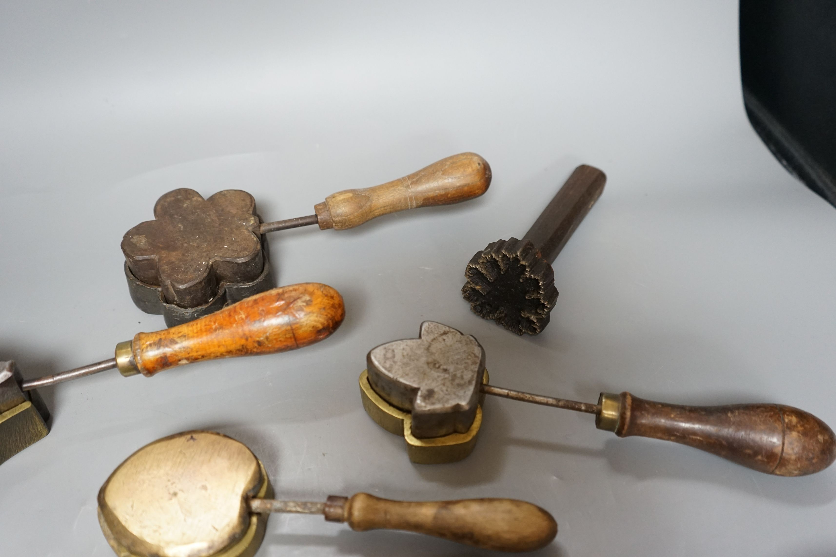 A collection of eight 19th century cast metal floral moulds, possibly for embossing silk